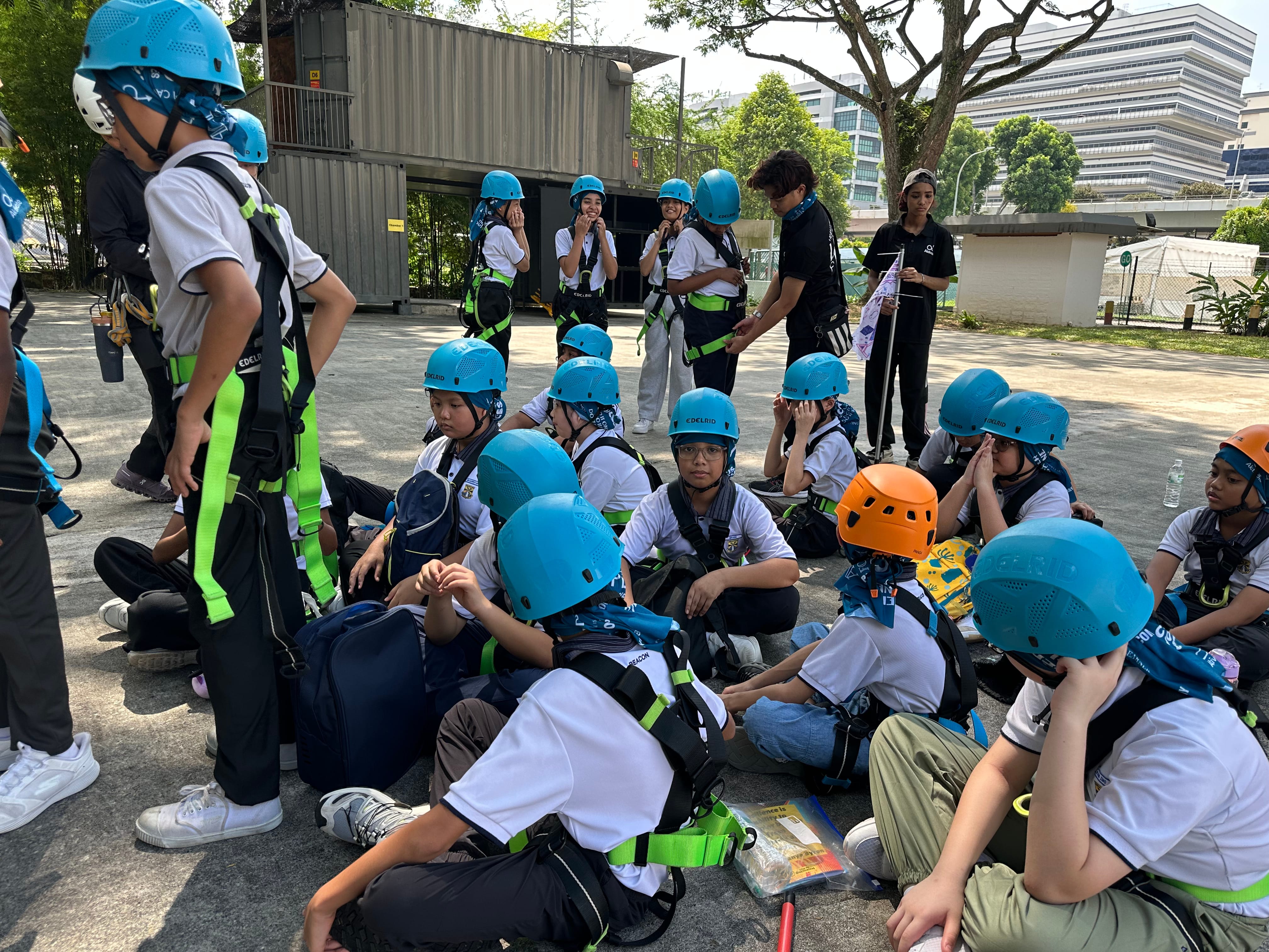 Fully geared up, students gather for a briefing before their next adventure activity.